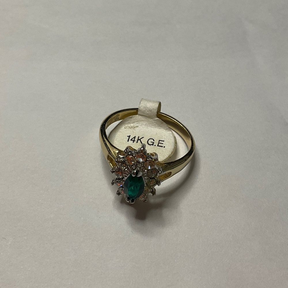 Elegant Gold Ring with Green Gemstone and Crystal Details